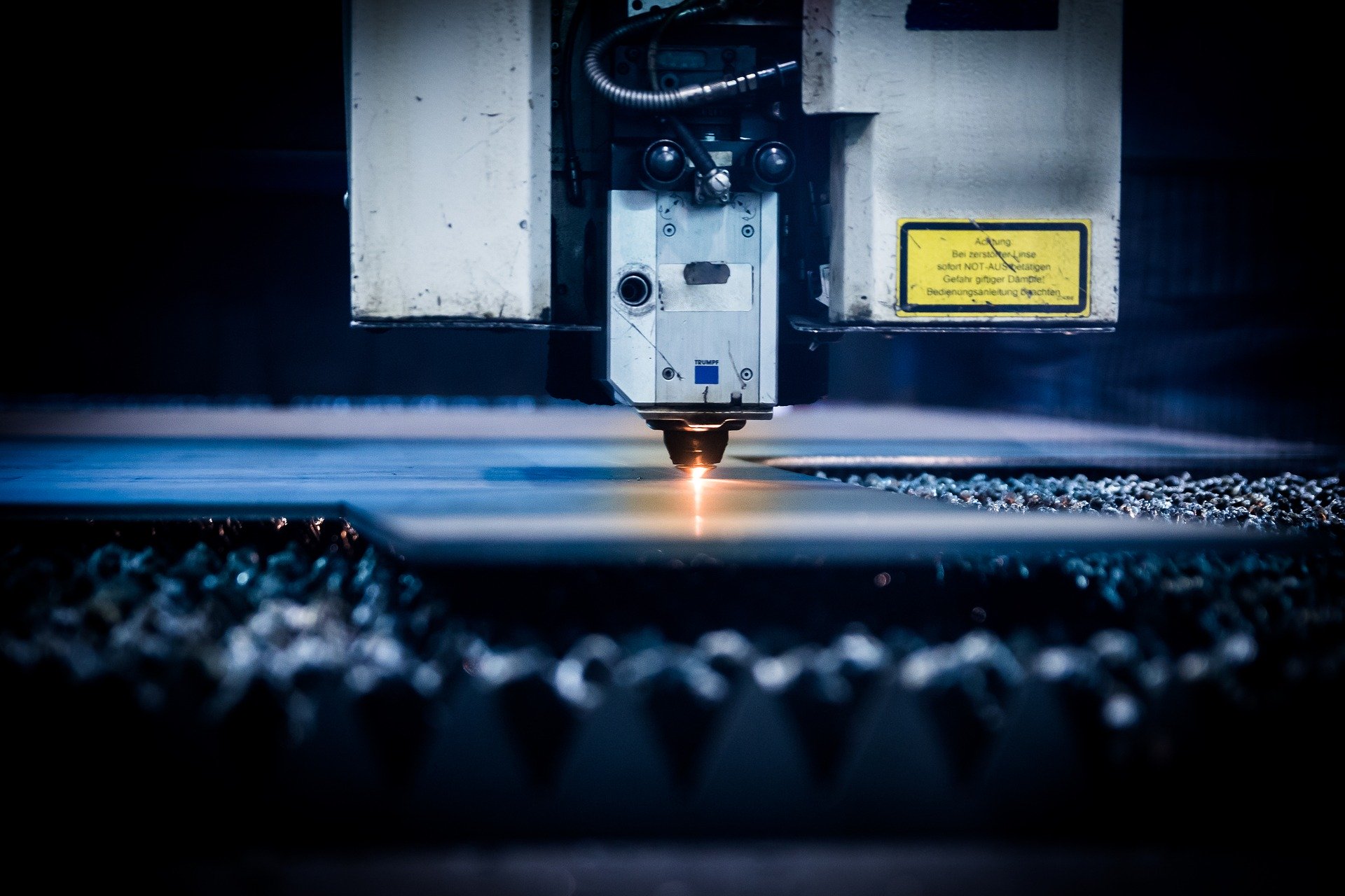Close-up of machine tool working a flat sheet of metal Close-up of machine tool working a flat sheet of metal