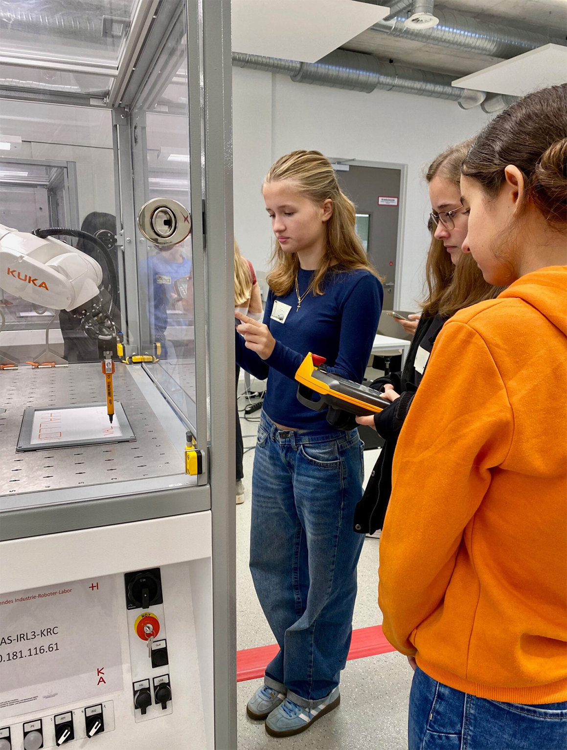 young women holding control panel in front of the machine tool young women holding control panel in front of the machine tool