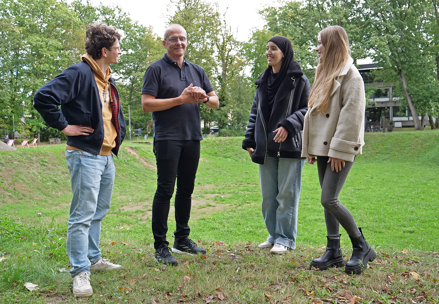 Die Hochschule Karlsruhe startet in das Wintersemester 2024/25 Prorektor Prof. Dr. Rainer Neumann auf dem Campus im Gespräch mit drei „Erstis“