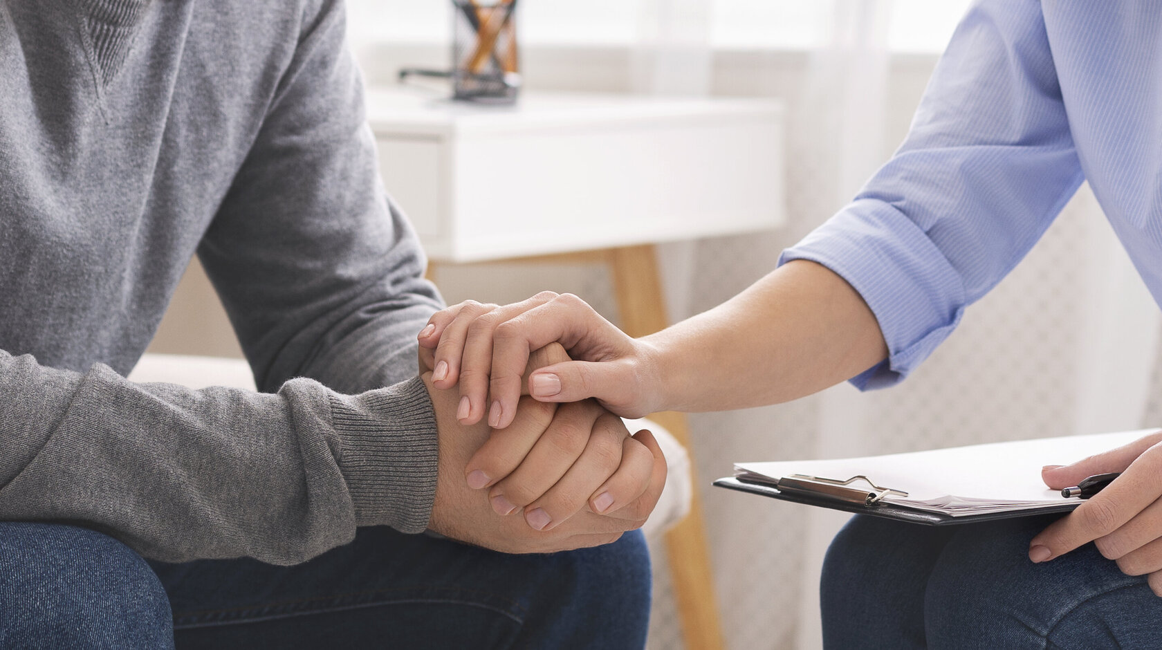Professional compassion. Psychotherapist supporting her depressed patient, panorama, close up