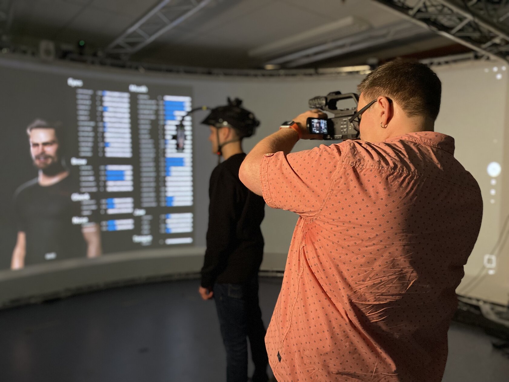 Cameraman Jan Holthaus was photographed from behind, filming Simon Janzer with his face-tracking technology