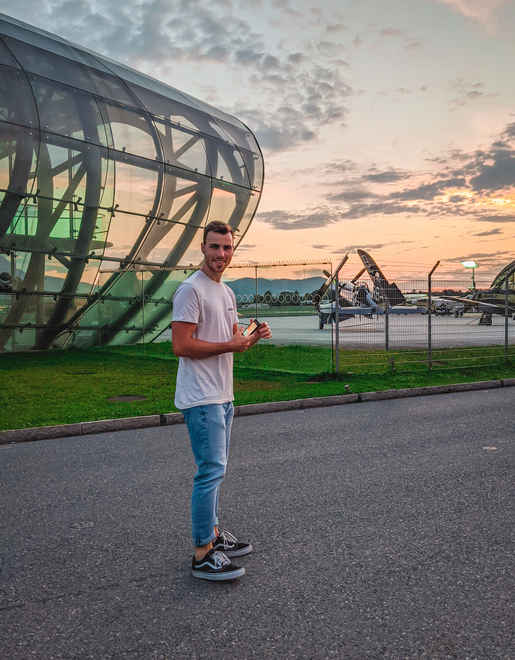 the student standing outside an airfield the student standing outside an airfield