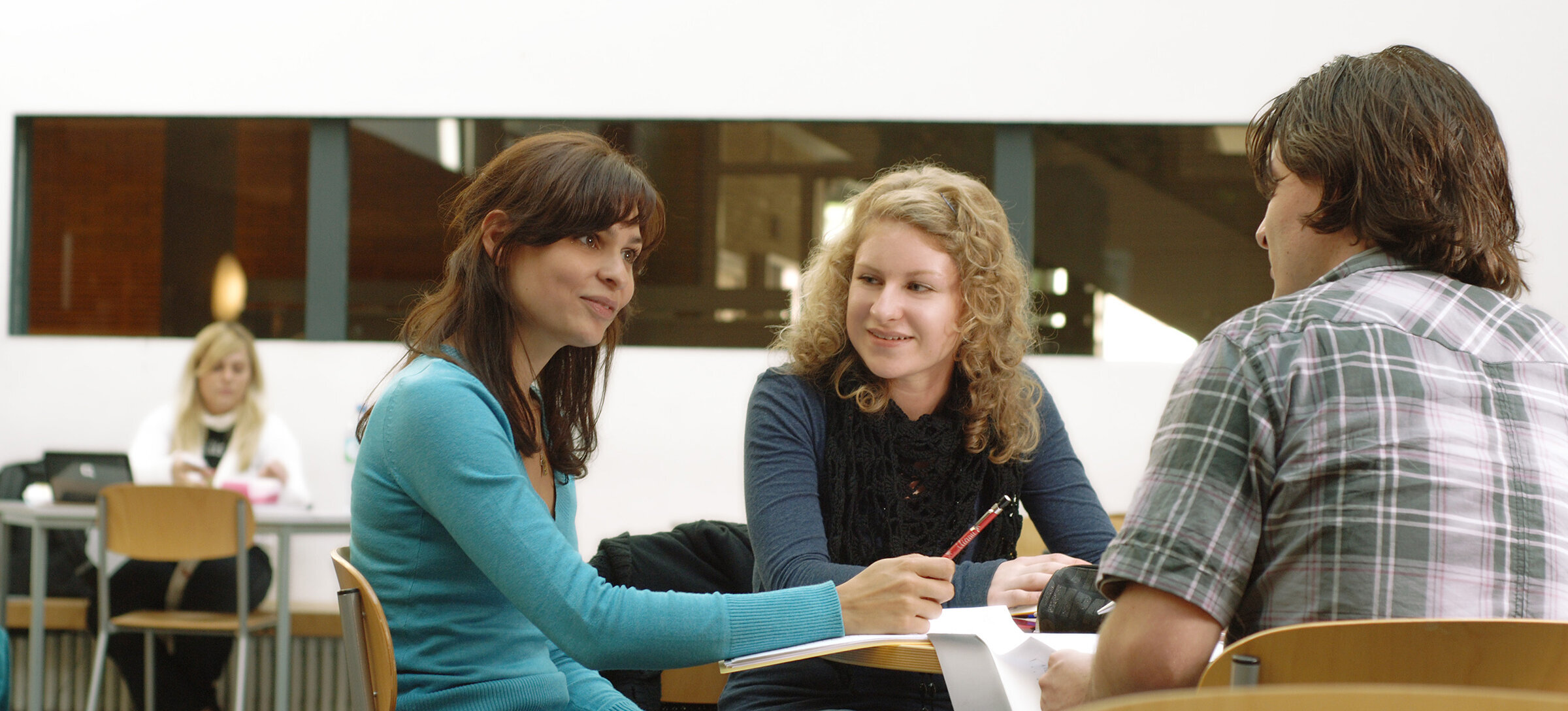 study group sitting in the Atrium of K building and learning together study group sitting in the Atrium of K building and learning together