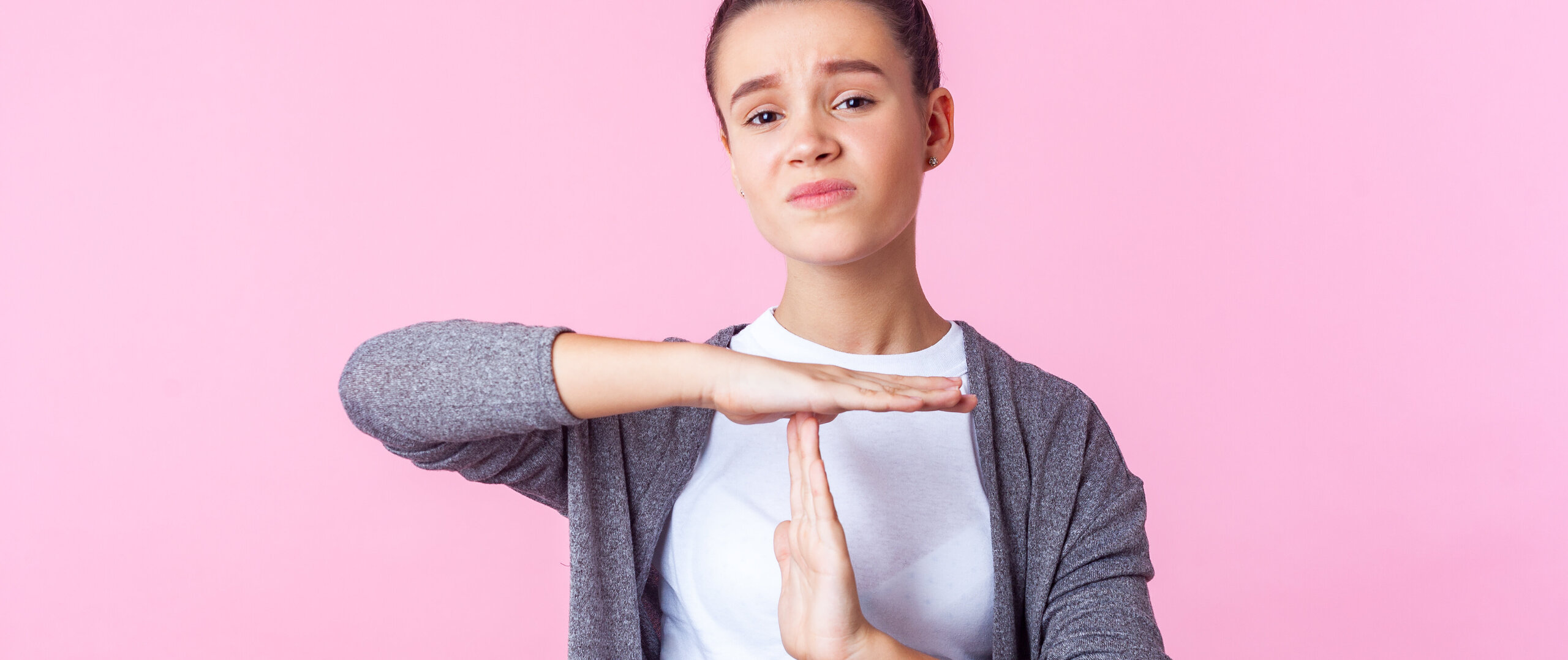 an unhappy young woman showing the "time out"-sign an unhappy young woman showing the "time out"-sign