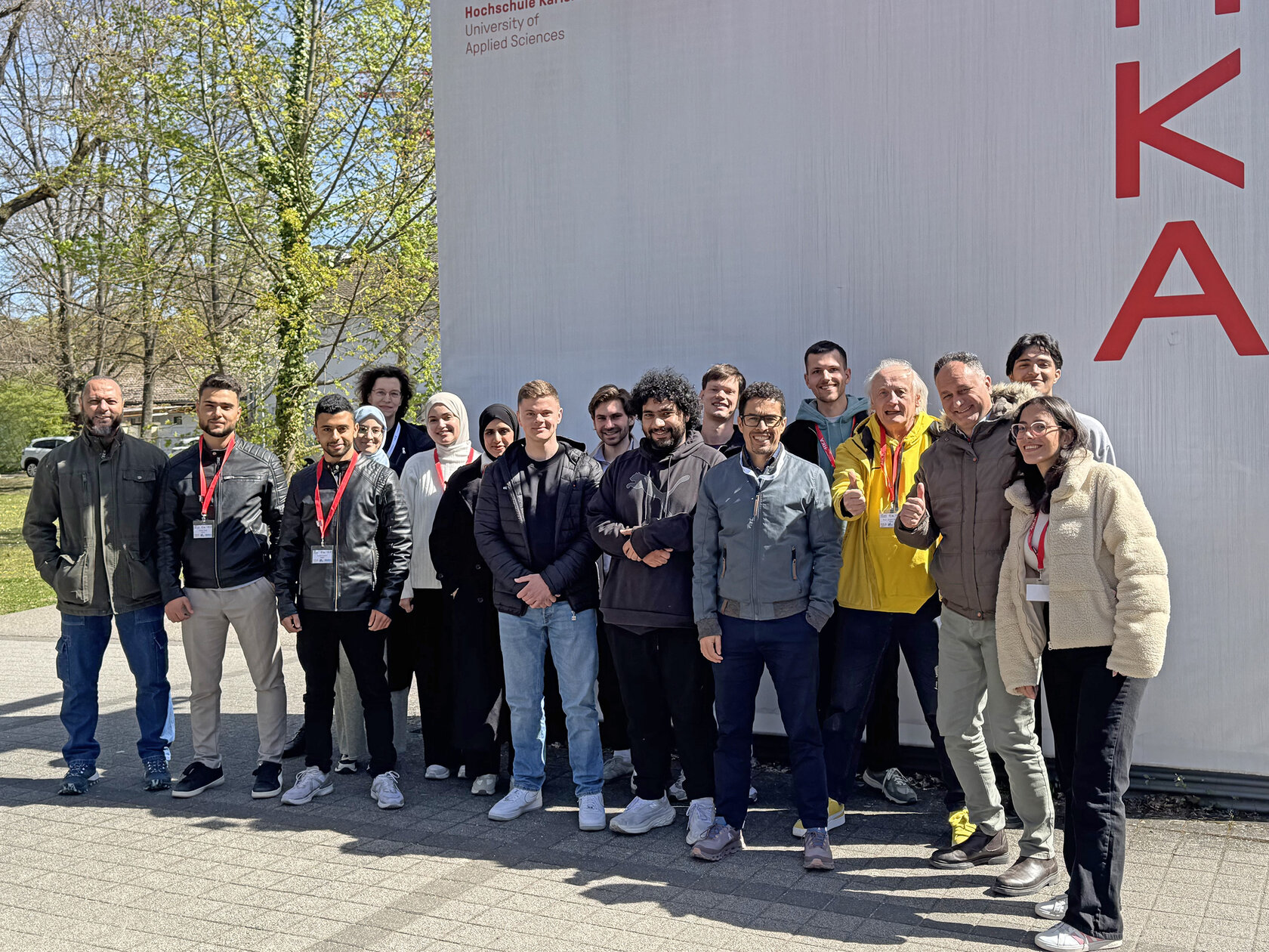 group of participants standing at entrance to HKA campus