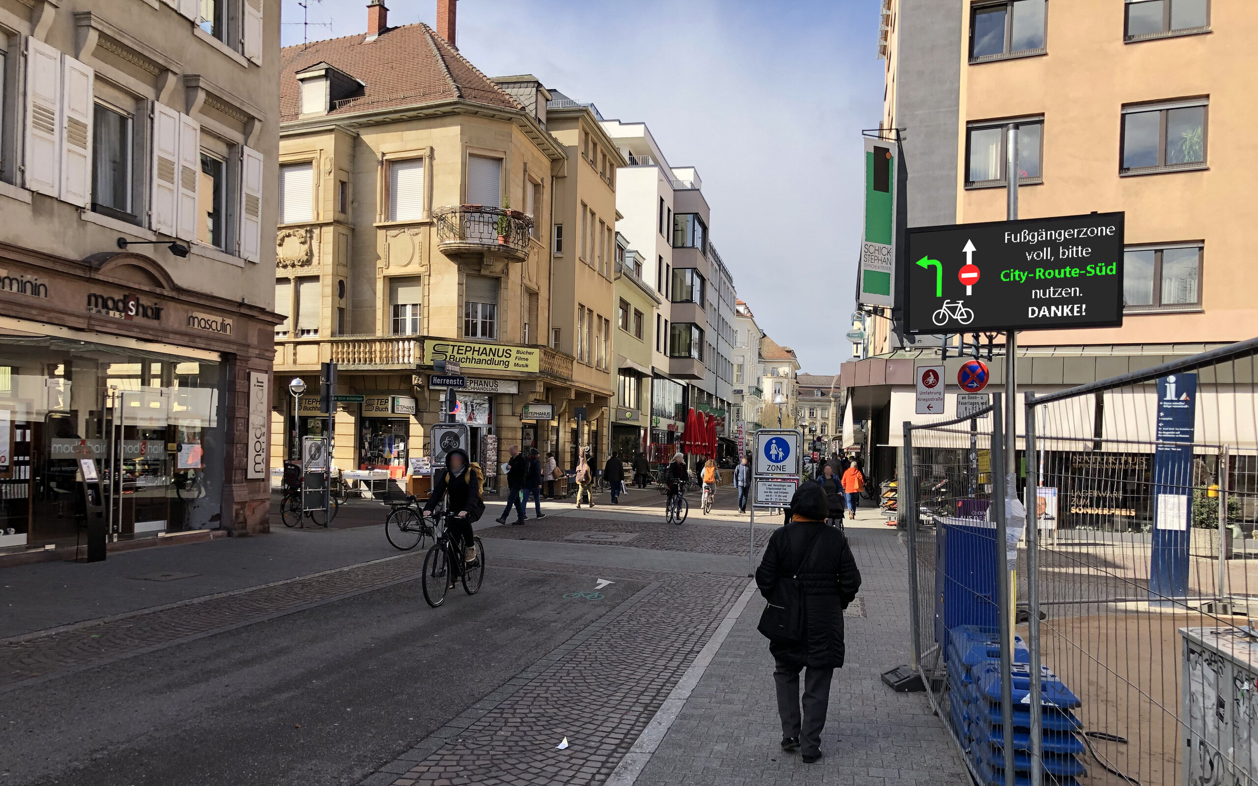 view of a street in Karlsruhe with shops, cyclists, and pedestrians view of a street in Karlsruhe with shops, cyclists, and pedestrians