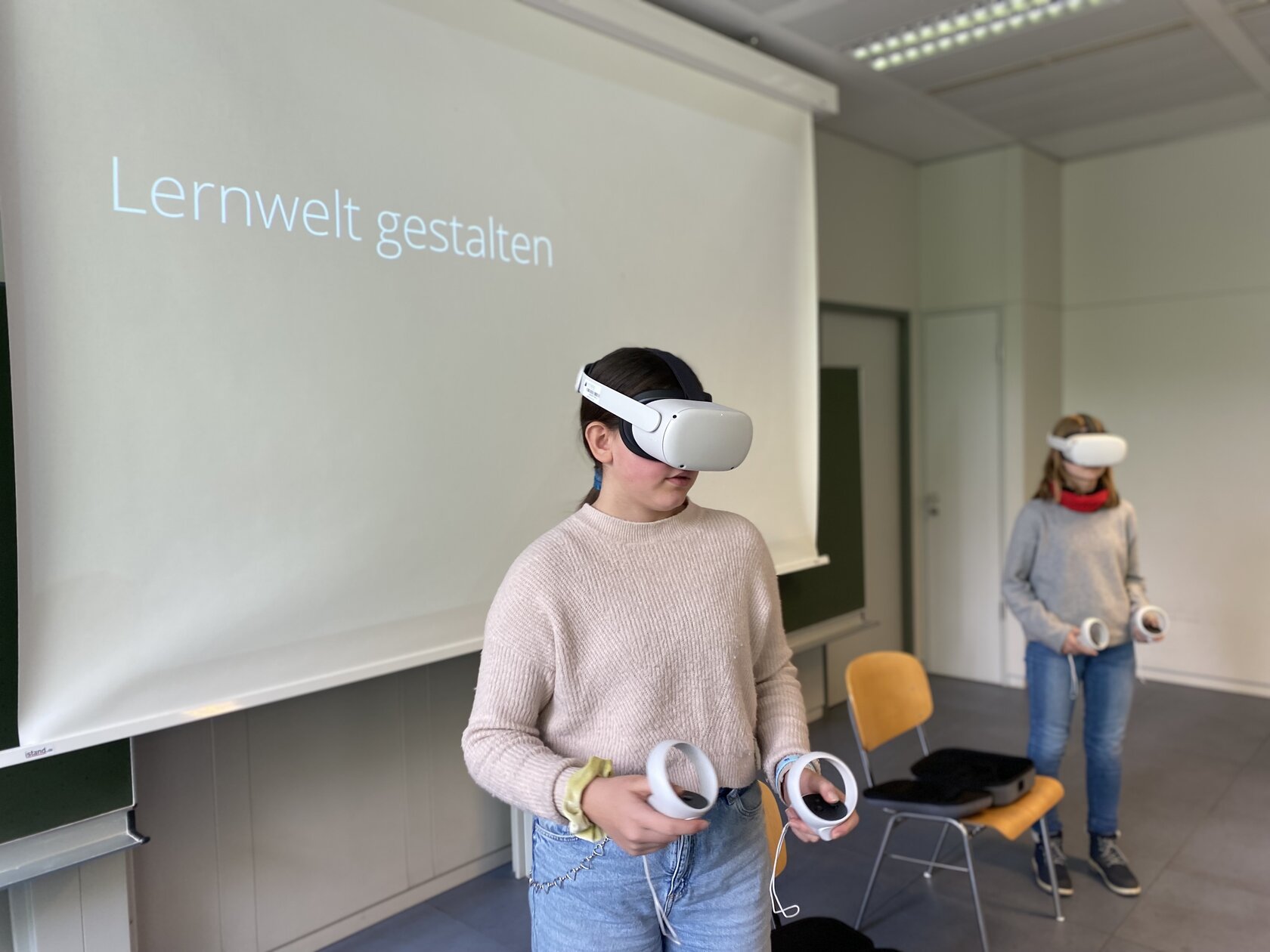 Two Girls' Day participants try out their learning worlds in VR.