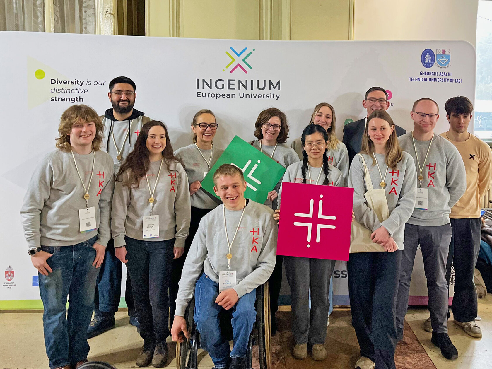 young people wearing HKA sweatshirts standing in front of INGENIUM banner