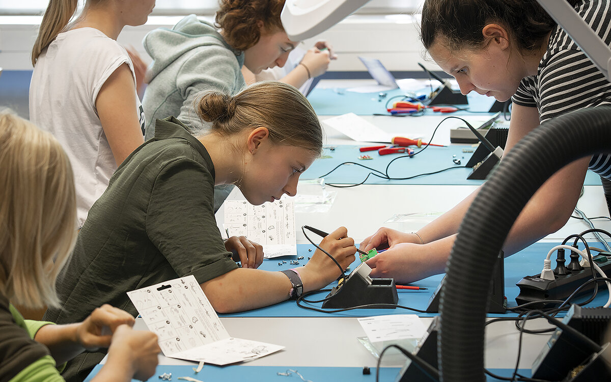 girls trying out measuring equipment